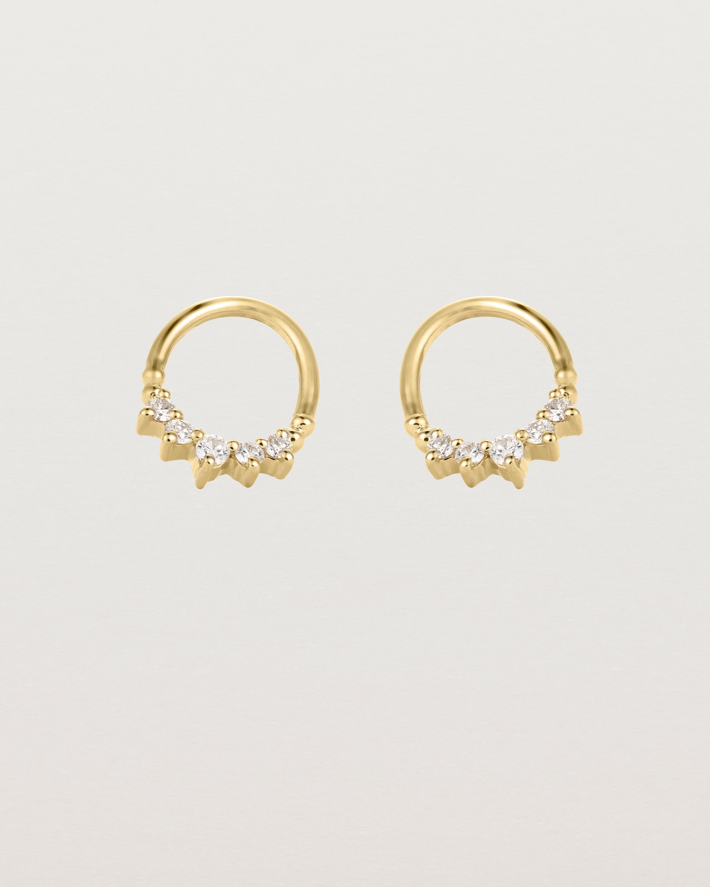 A pair of yellow gold oval studs with five white diamonds