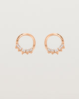 A pair of rose gold oval studs with five white diamonds