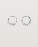 A pair of white gold oval studs with five white diamonds