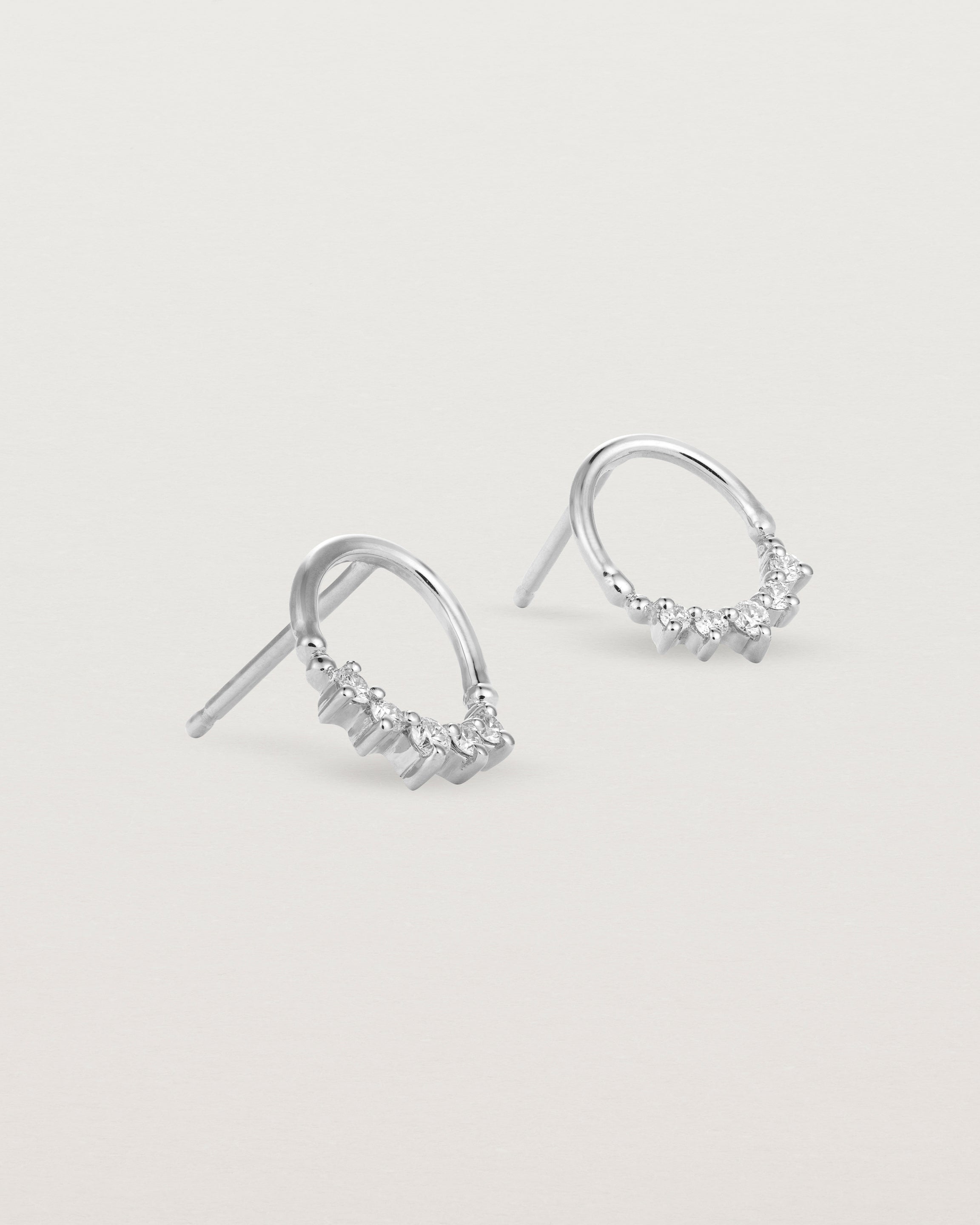 A pair of white gold oval studs with five white diamonds