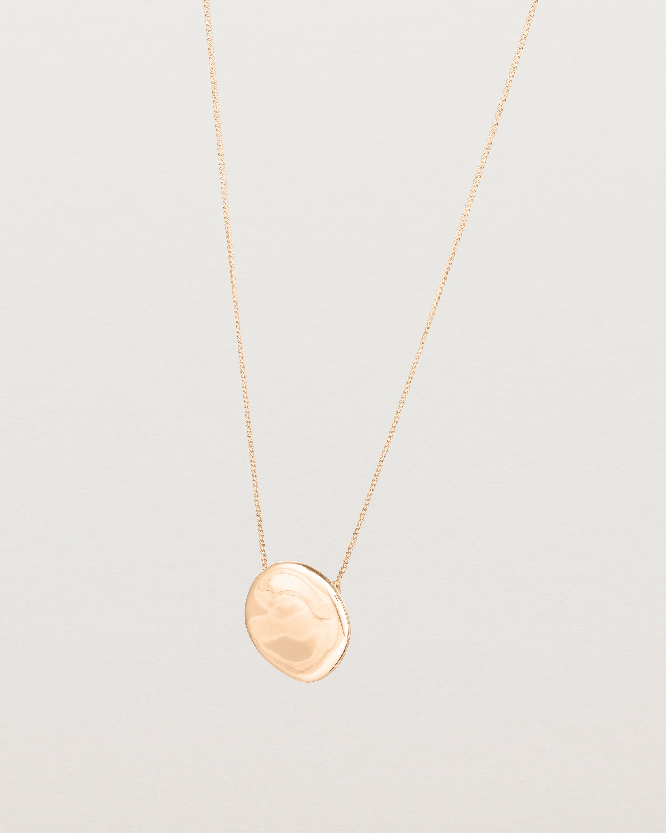 Angled view of the Mana Necklace in rose gold.