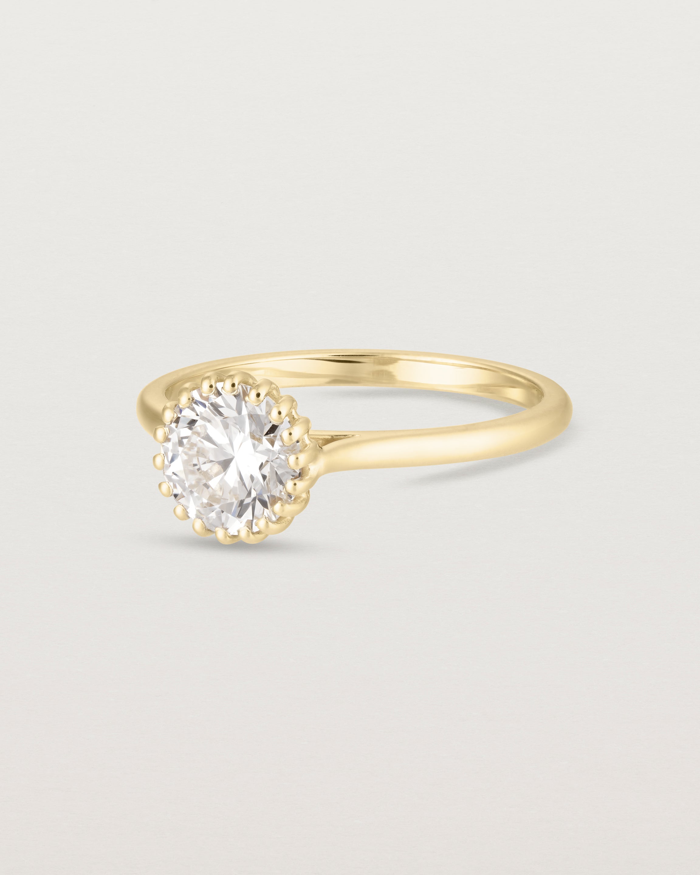Angled view of the Meroë Round Solitaire | Laboratory Grown Diamond in yellow gold