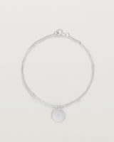 A sterling silver chain bracelet featuring a disc with an engraved letter m
