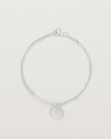 A sterling silver chain bracelet featuring a disc with an engraved letter m