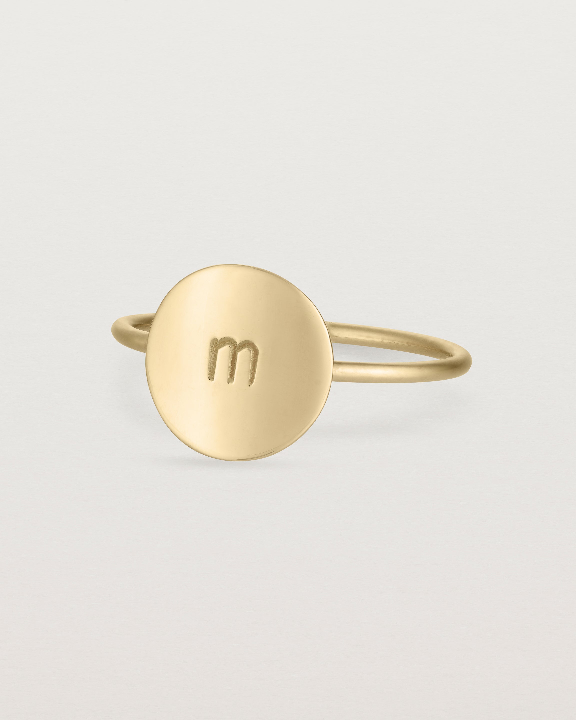 Angled view of the Mini Initial Ring in Yellow Gold.