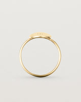Standing view of the Mini Initial Ring in Yellow Gold.
