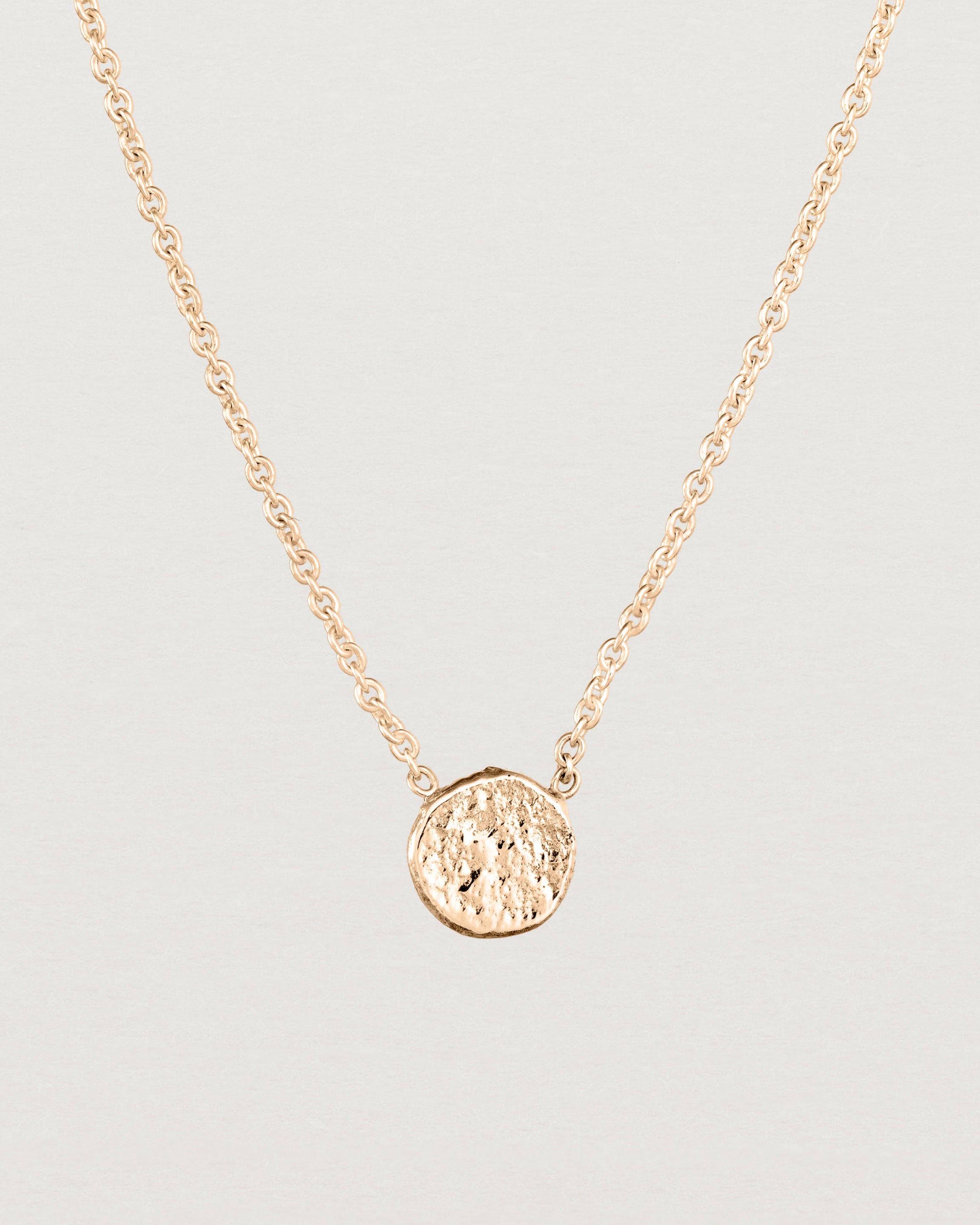 Close up view of the Moon Necklace in rose gold.