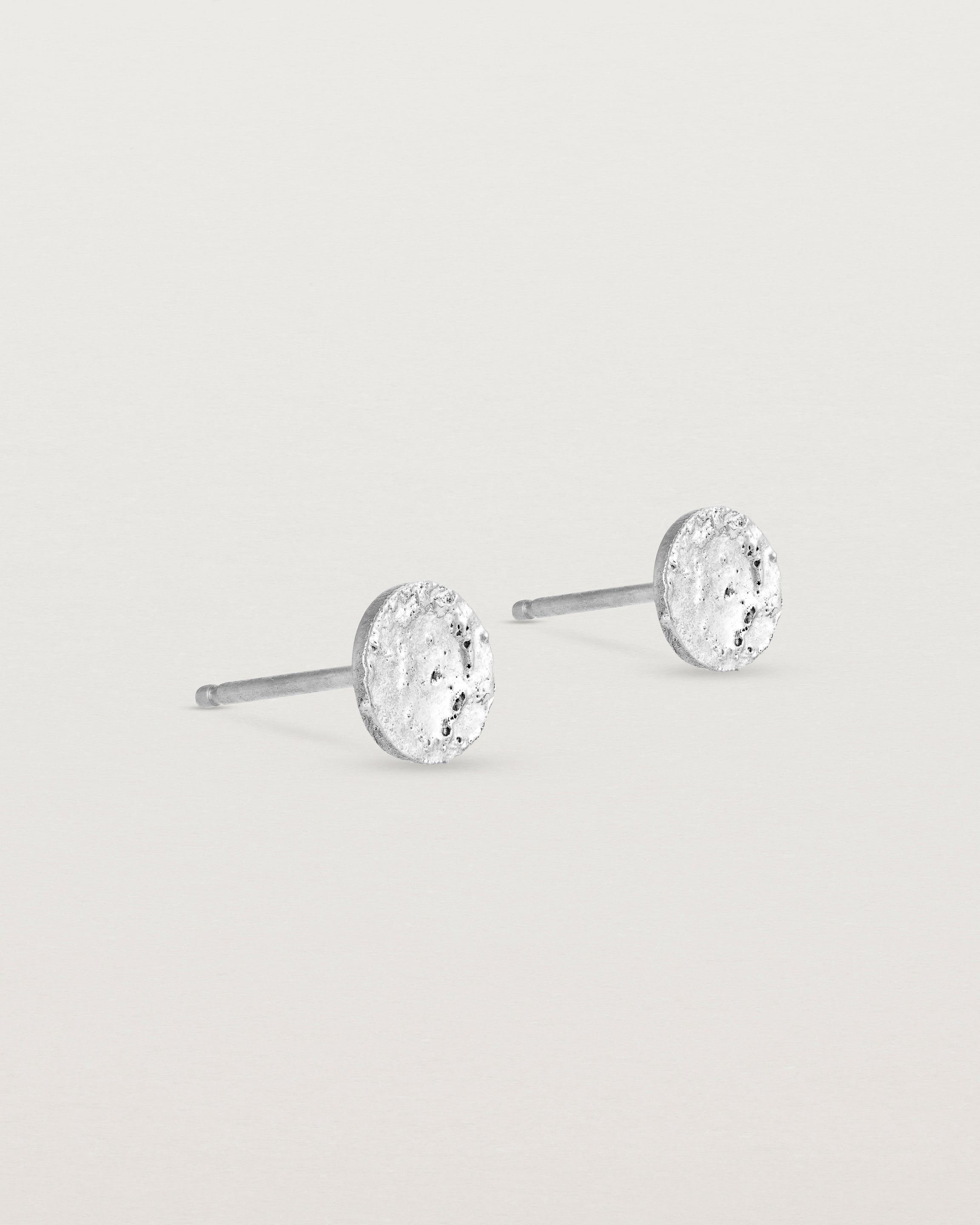 A pair of textured circular sterling silver studs