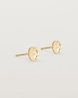 A pair of textured circular yellow gold studs