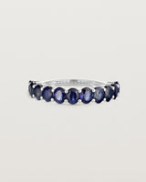 front on deep etched image of a white gold wrap engagement ring with 11 sapphire stones.