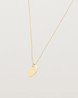 An engraved yellow gold pendant
