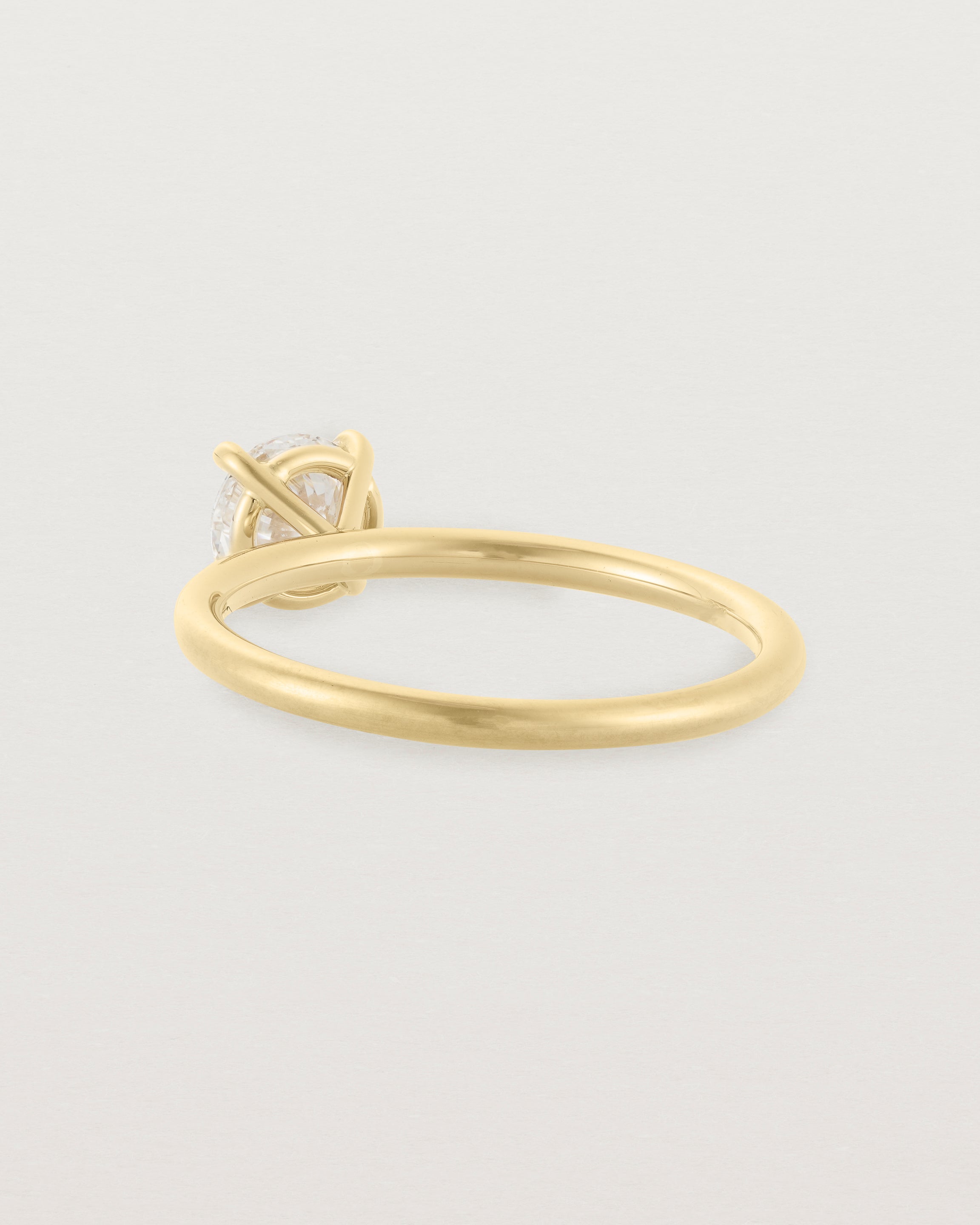 Back view of a 0.74ct white diamond is simply set amongst four claws and crafted in 18ct Yellow Gold