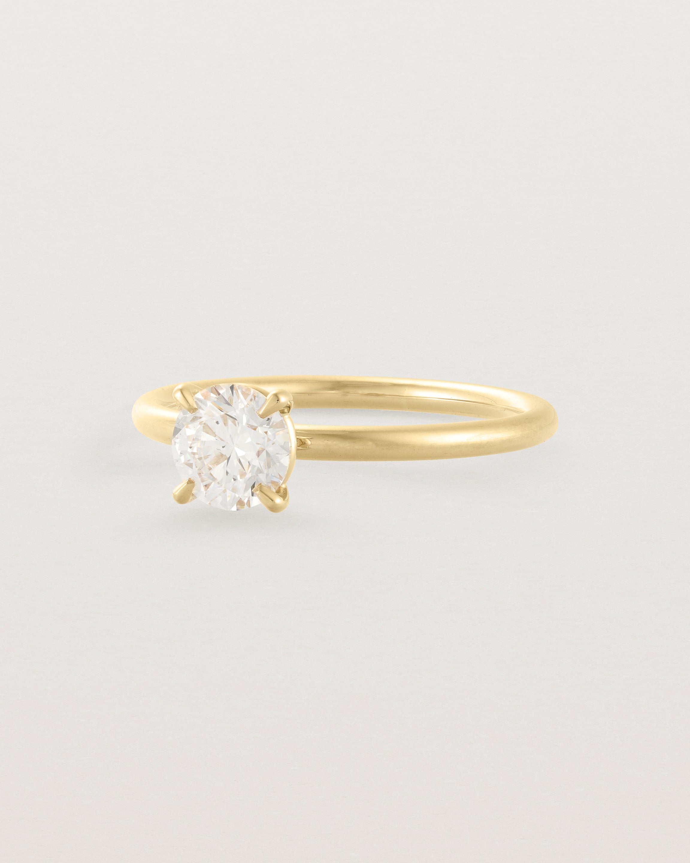 Side view of a 0.74ct white diamond is simply set amongst four claws and crafted in 18ct Yellow Gold