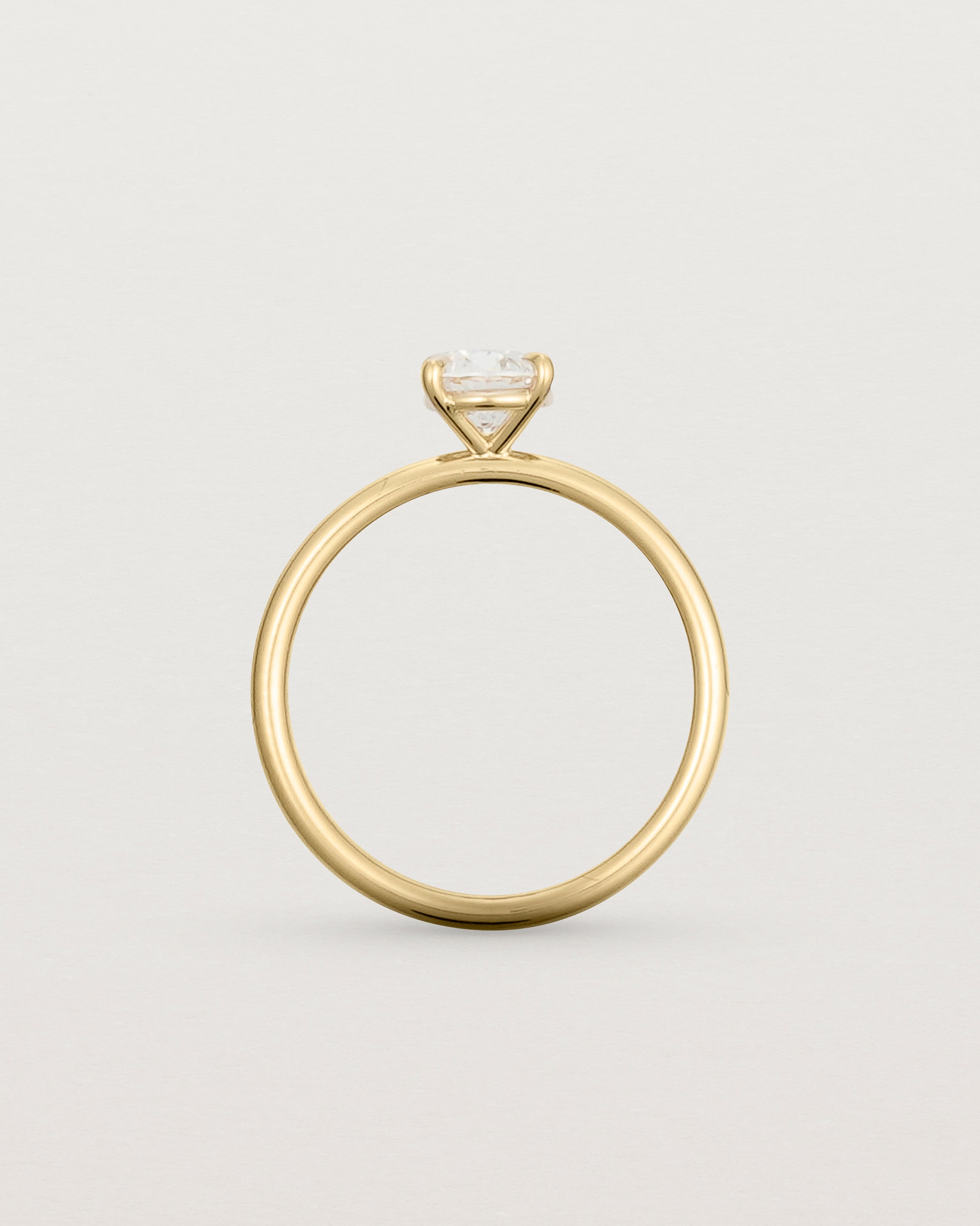 Side profile of a 0.74ct white diamond is simply set amongst four claws and crafted in 18ct Yellow Gold