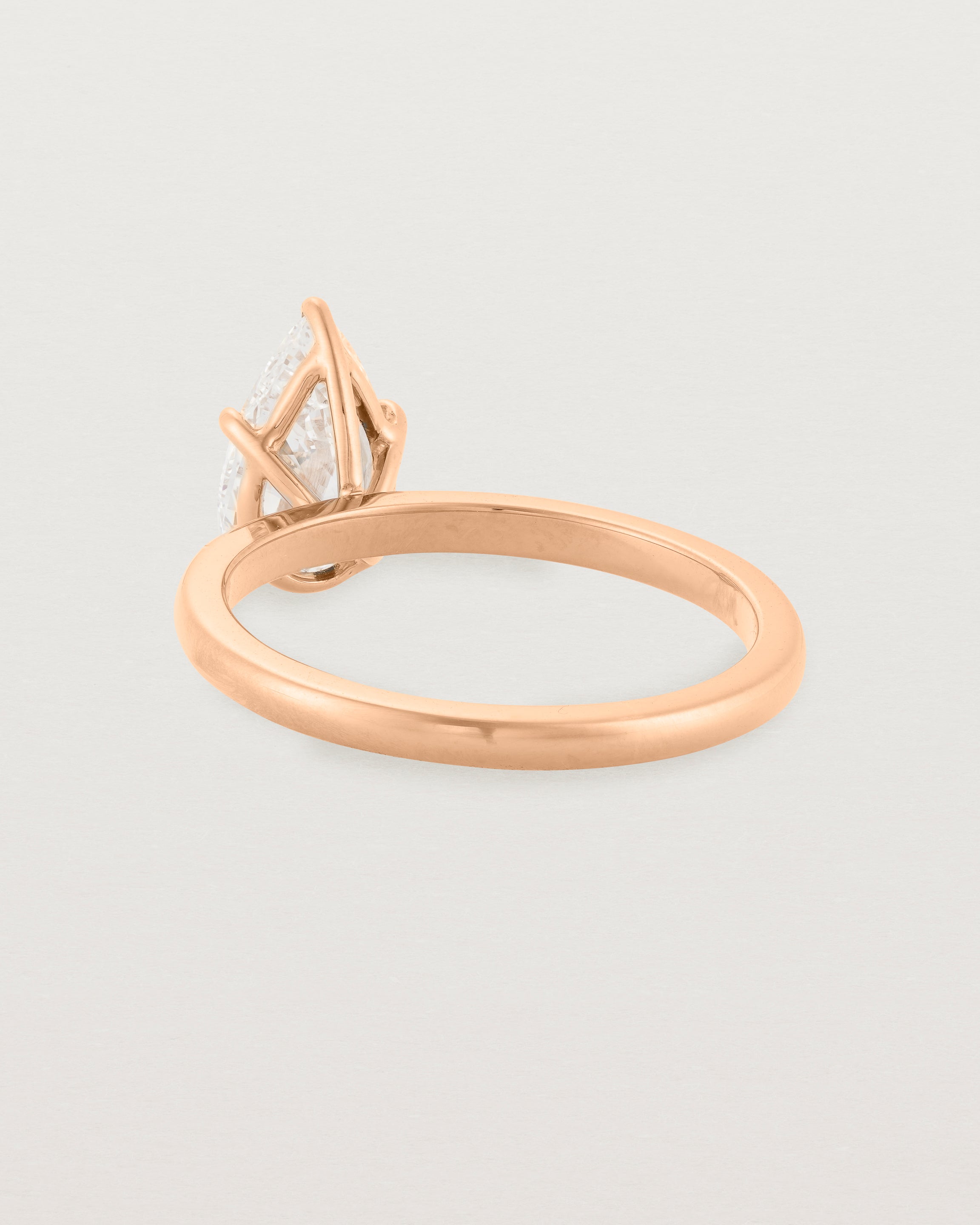 Back view of a 1.20ct pear cut diamond set in our Signature Solitaire setting crafted in rose gold