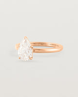 Side profile of a 1.20ct pear cut diamond set in our Signature Solitaire setting crafted in rose gold