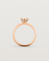 Side profile of a 1.20ct pear cut diamond set in our Signature Solitaire setting crafted in rose gold