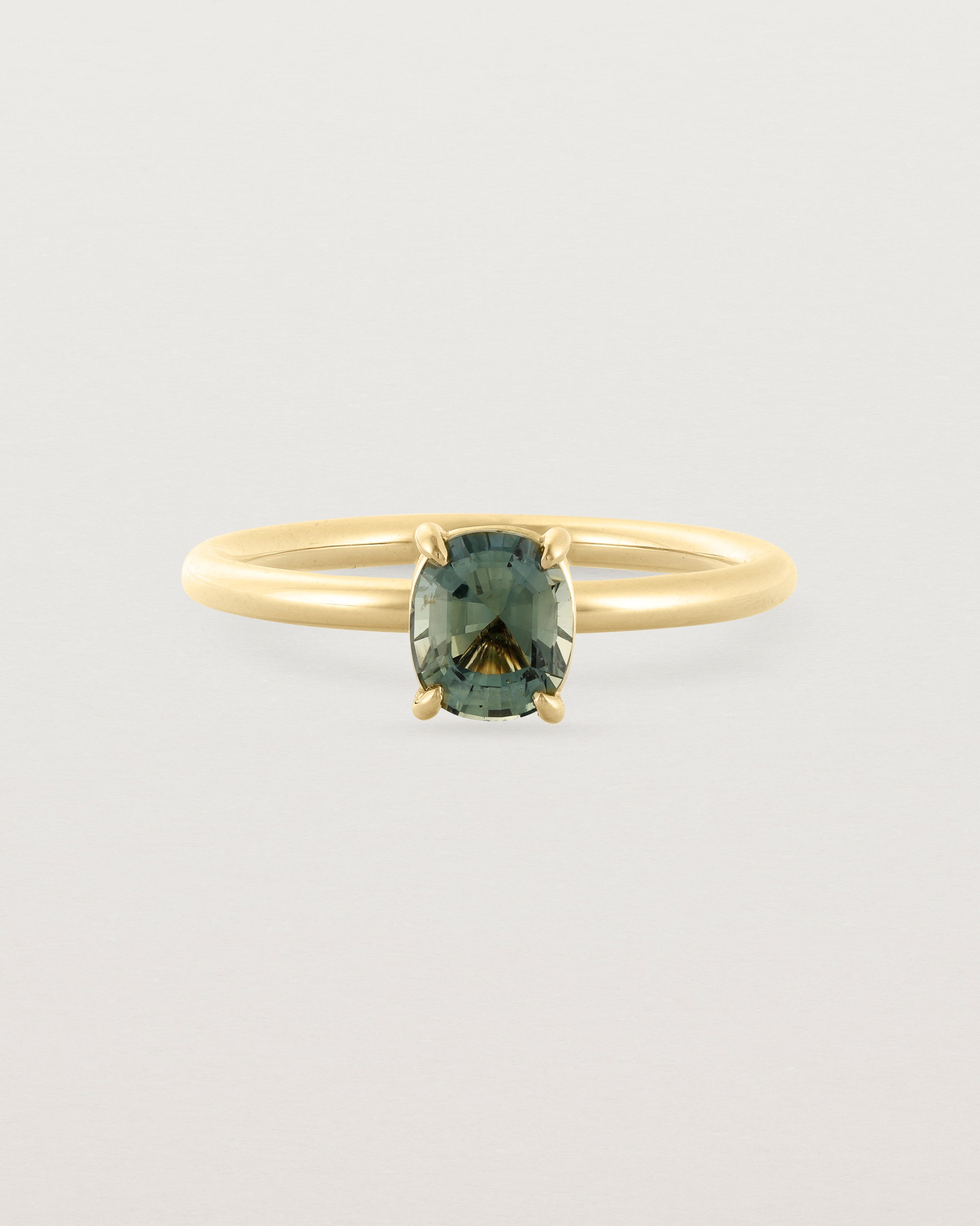 A striking 0.89 cushion cut Parti Sapphire, sits pretty on a 1.6mm round band and crafted in 18ct Yellow Gold.
