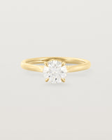 A 0.90ct round white diamond, adorns a 1.6mm half round 18ct Yellow Gold band. 