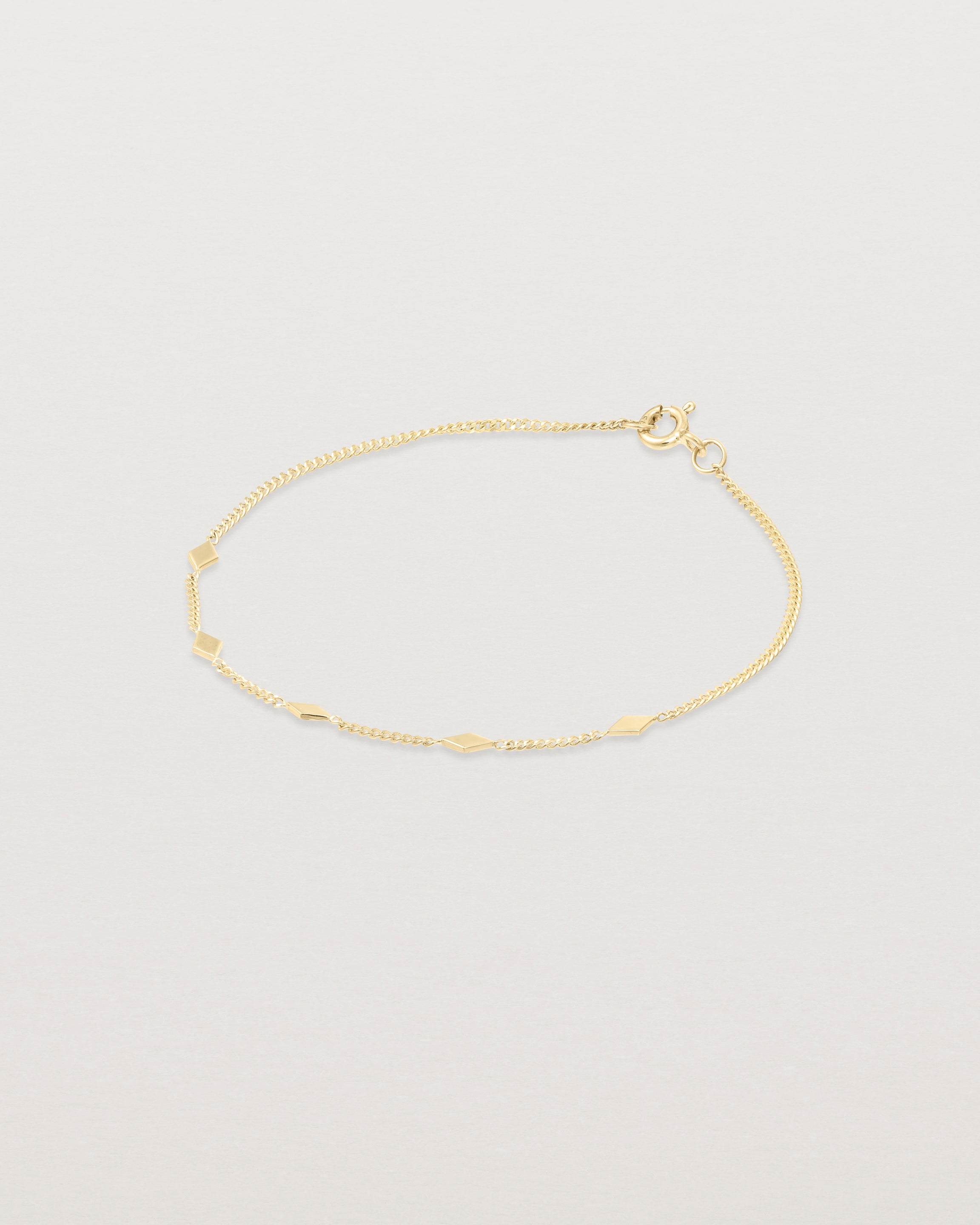 Angled view of the Nuna Charm Bracelet in Yellow Gold.