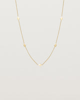 Front view of the Nuna Charm Necklace in yellow gold.