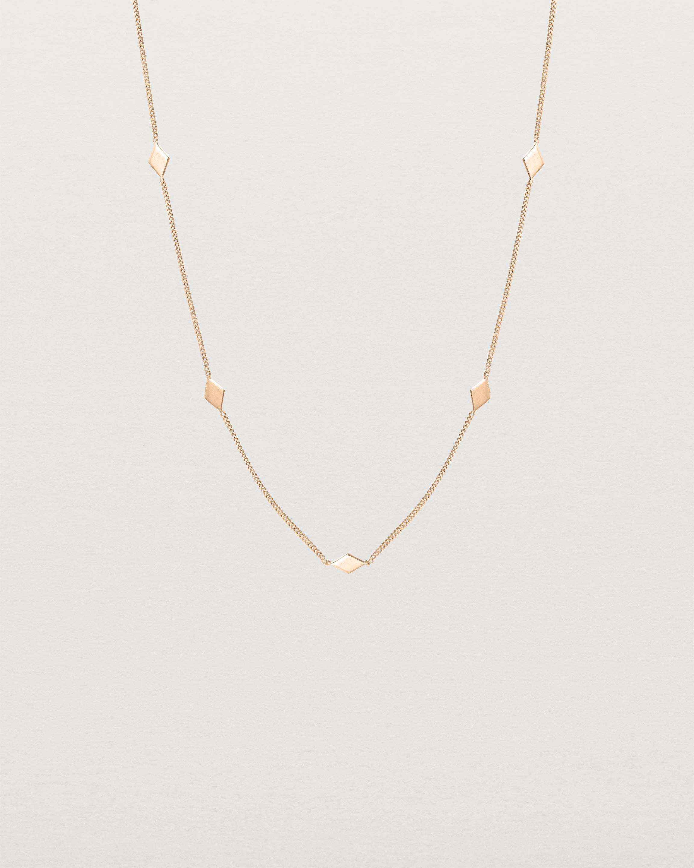 Front view of the Nuna Charm Necklace in rose gold.