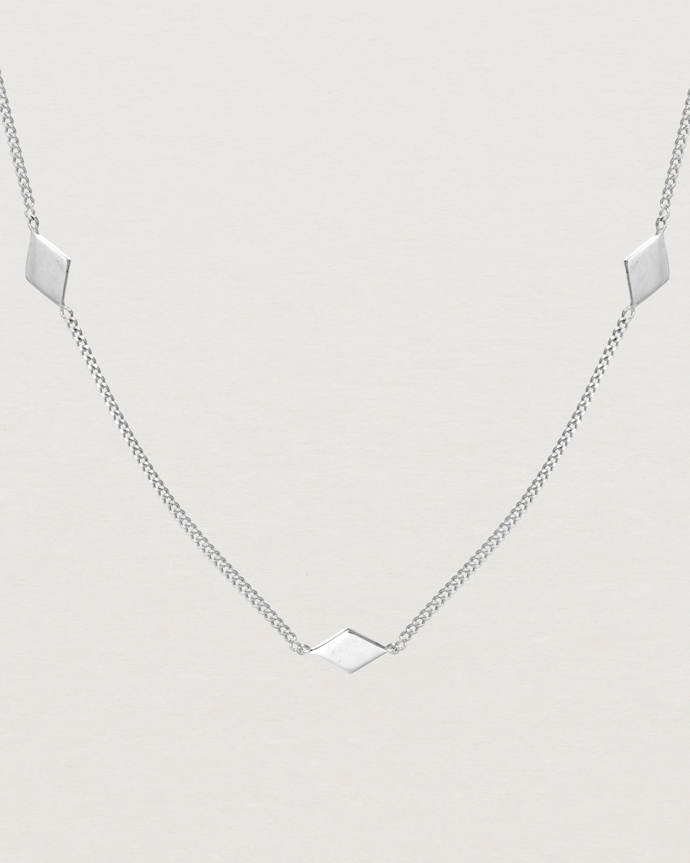 Close up view of the Nuna Charm Necklace in sterling silver.