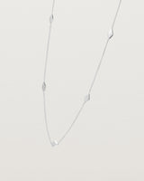 Angled view of the Nuna Charm Necklace in sterling silver.