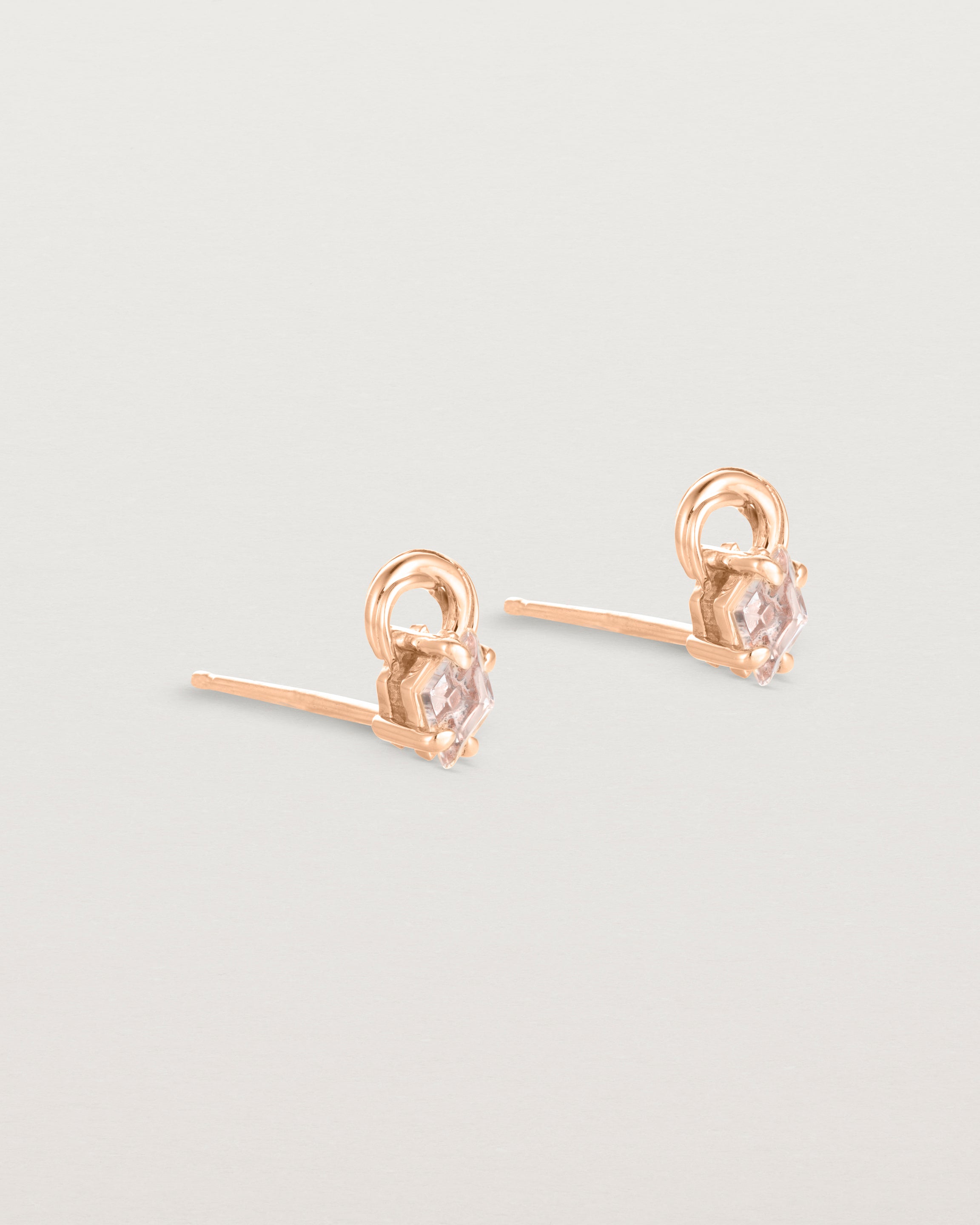 A pair of rose gold studs featuring an ascher cut pale yellow sunstone