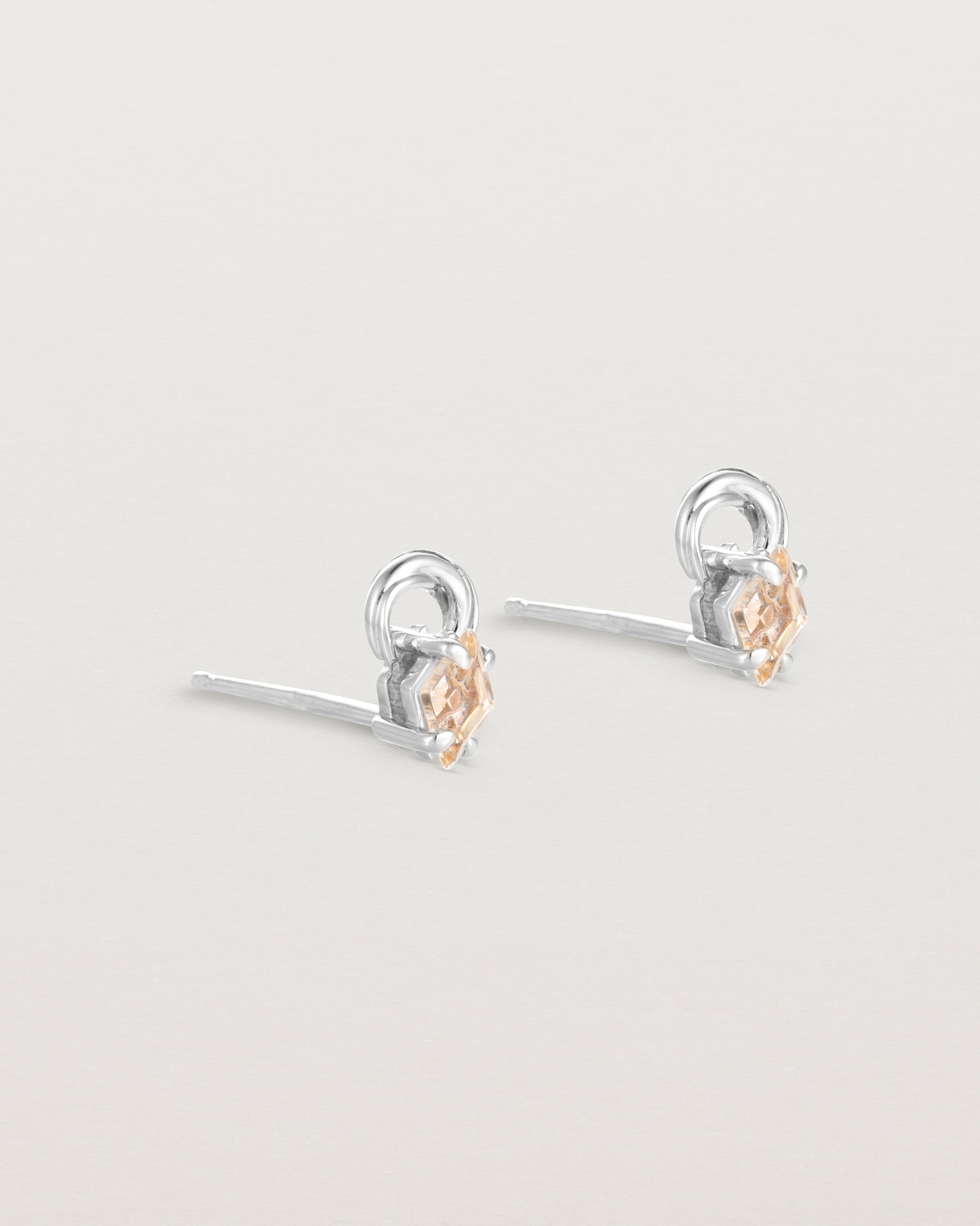 A pair of sterling silver studs featuring an ascher cut pale yellow sunstone
