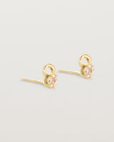 A pair of yellow gold studs featuring an ascher cut pale yellow sunstone
