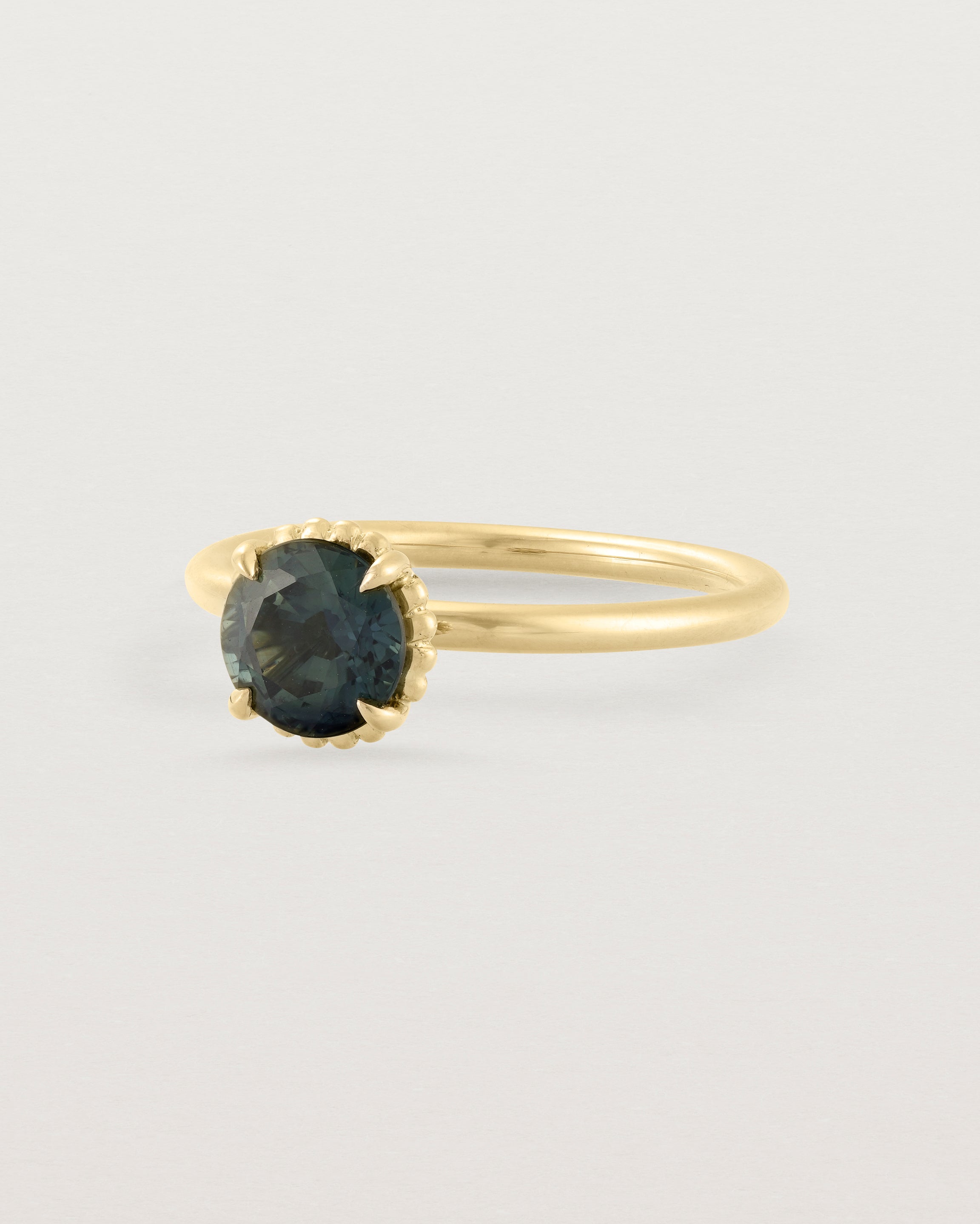 Angled view of the Celia | Round Tulip Solitaire | Teal Sapphire.