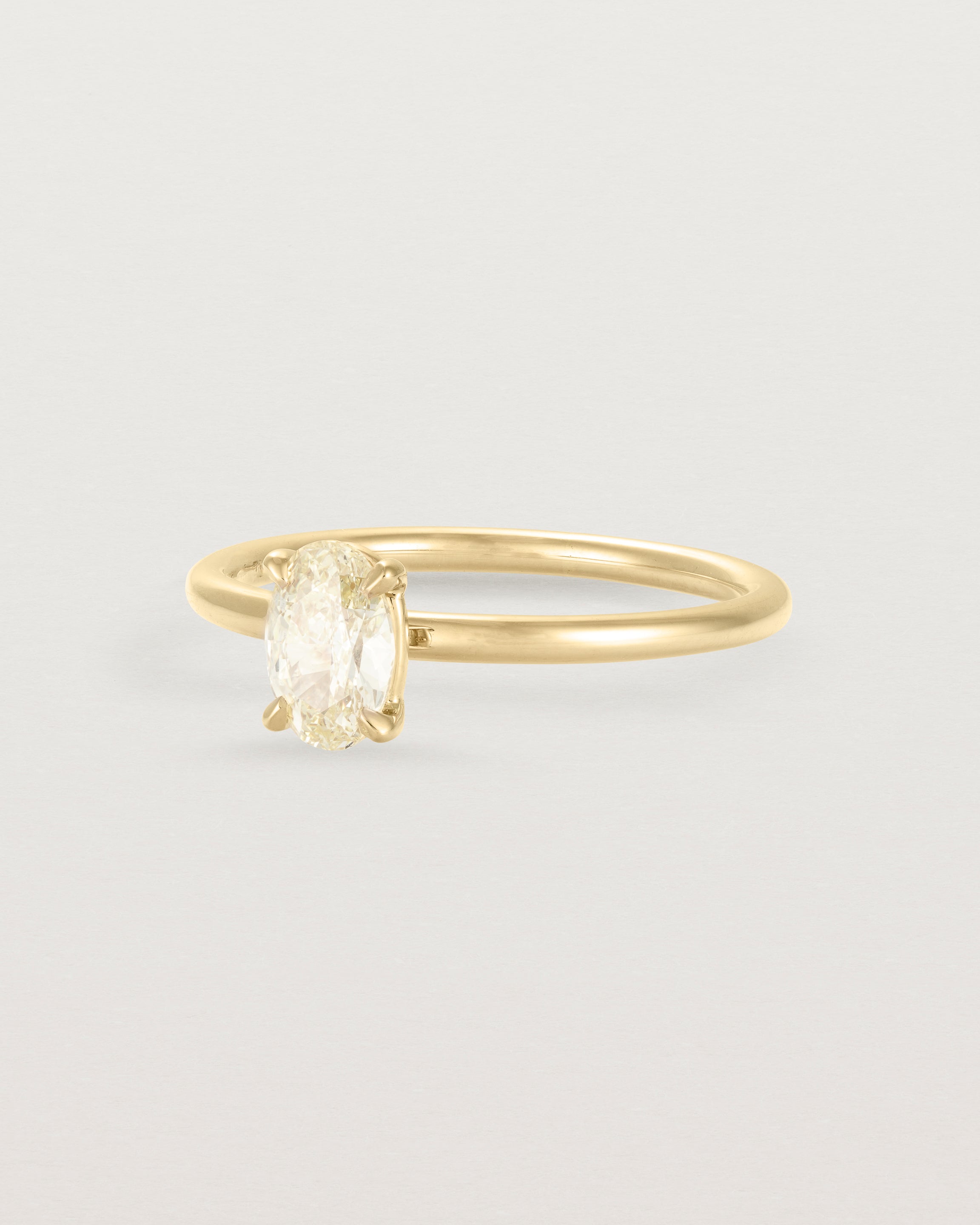 Side view of a Yellow Diamond Signature Solitaire in Yellow Gold 