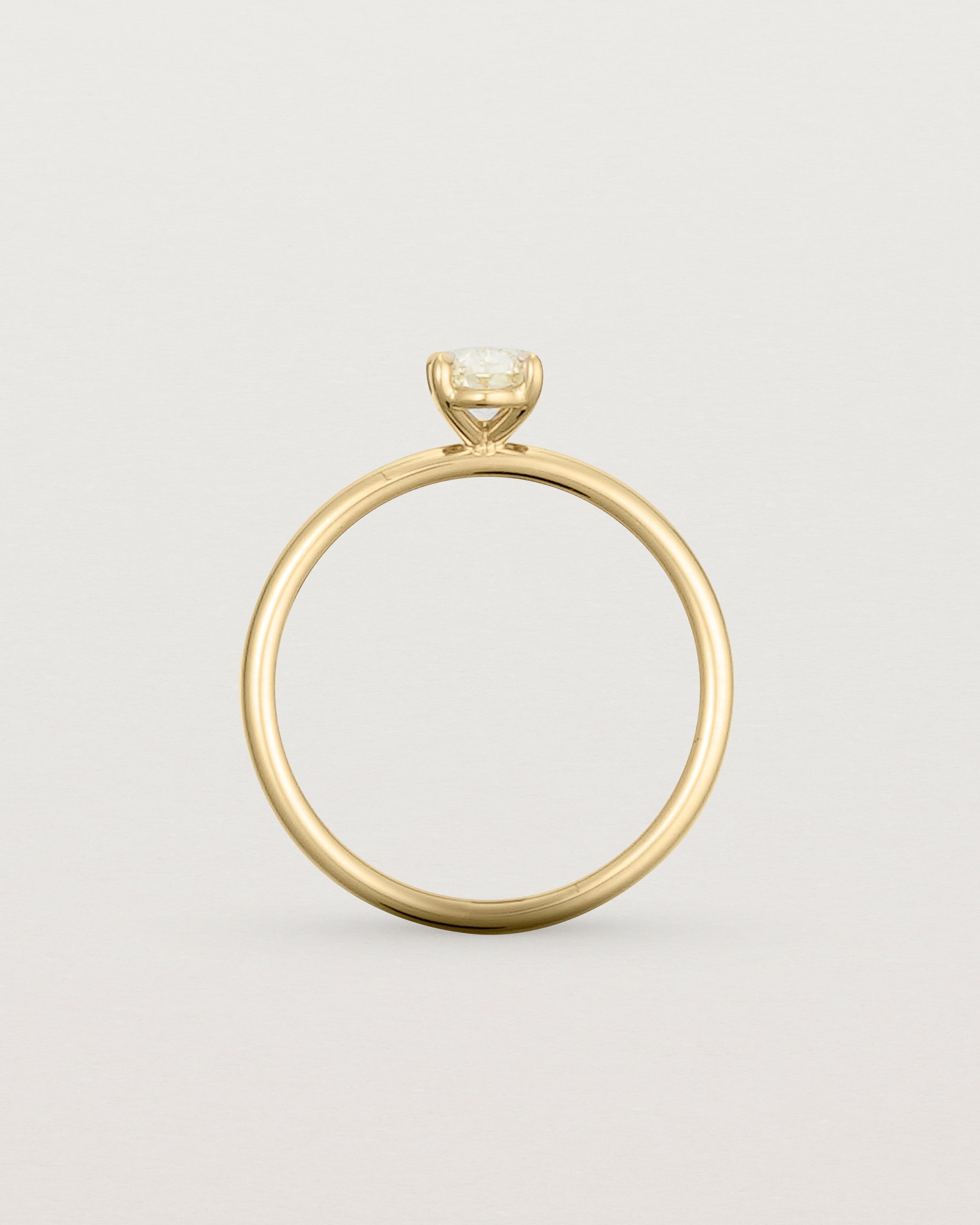 Profile view of a Yellow Diamond Signature Solitaire in Yellow Gold