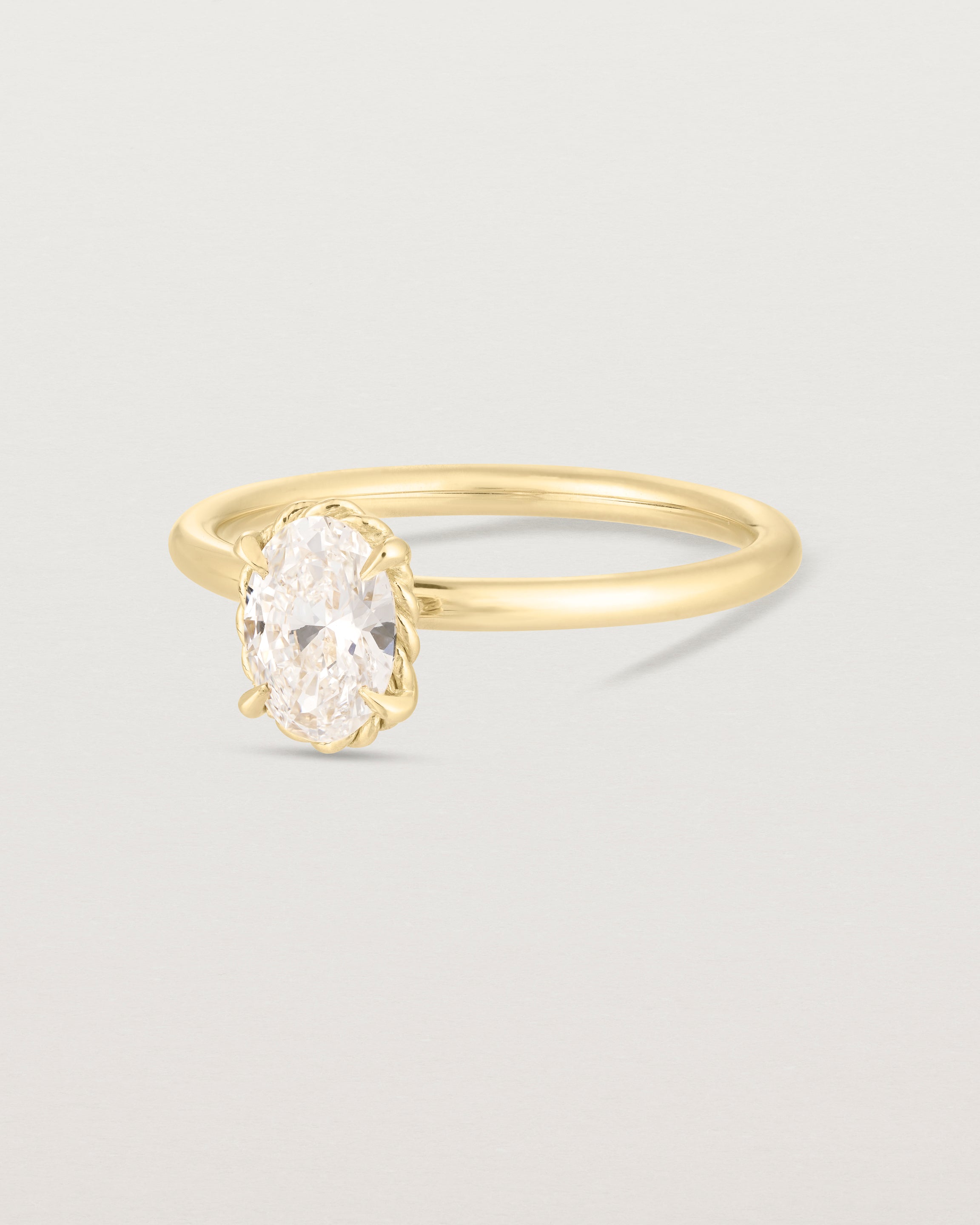 Side image of yellow gold oval diamond solitaire