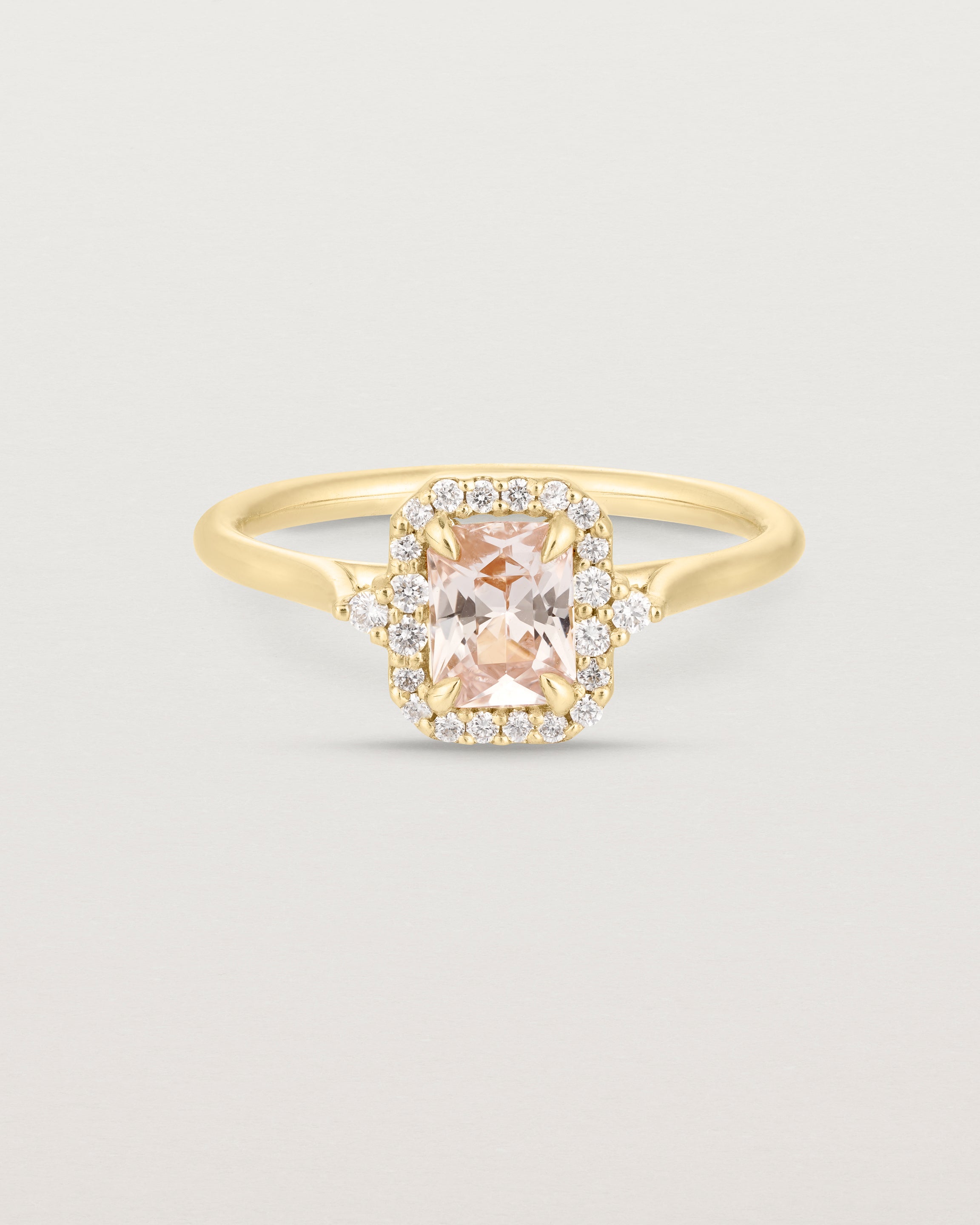 Front image of the winona ring with a peach sapphire in yellow gold.