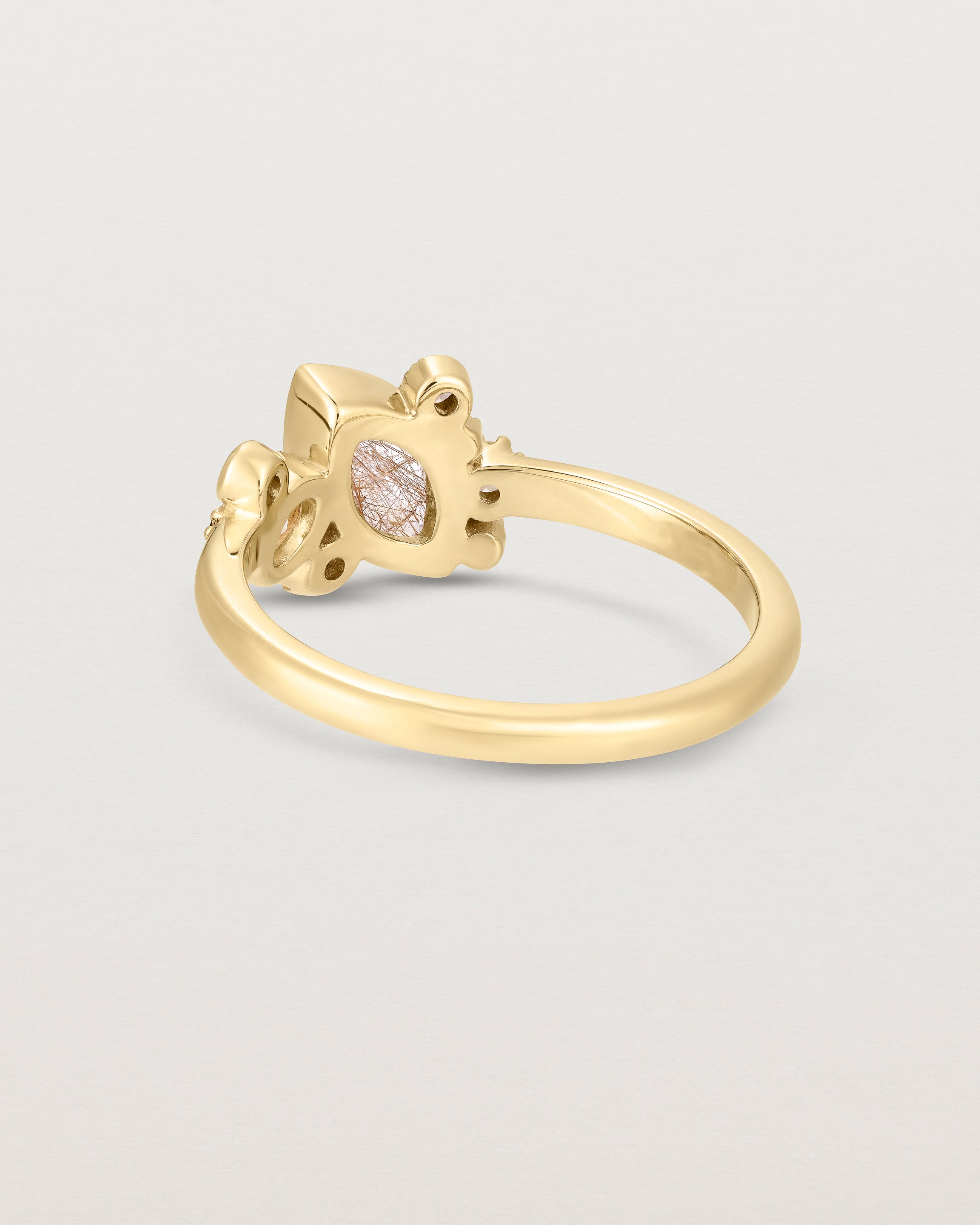 Product image of a yellow gold engagement ring with a rutilated quartz and diamonds, back view.