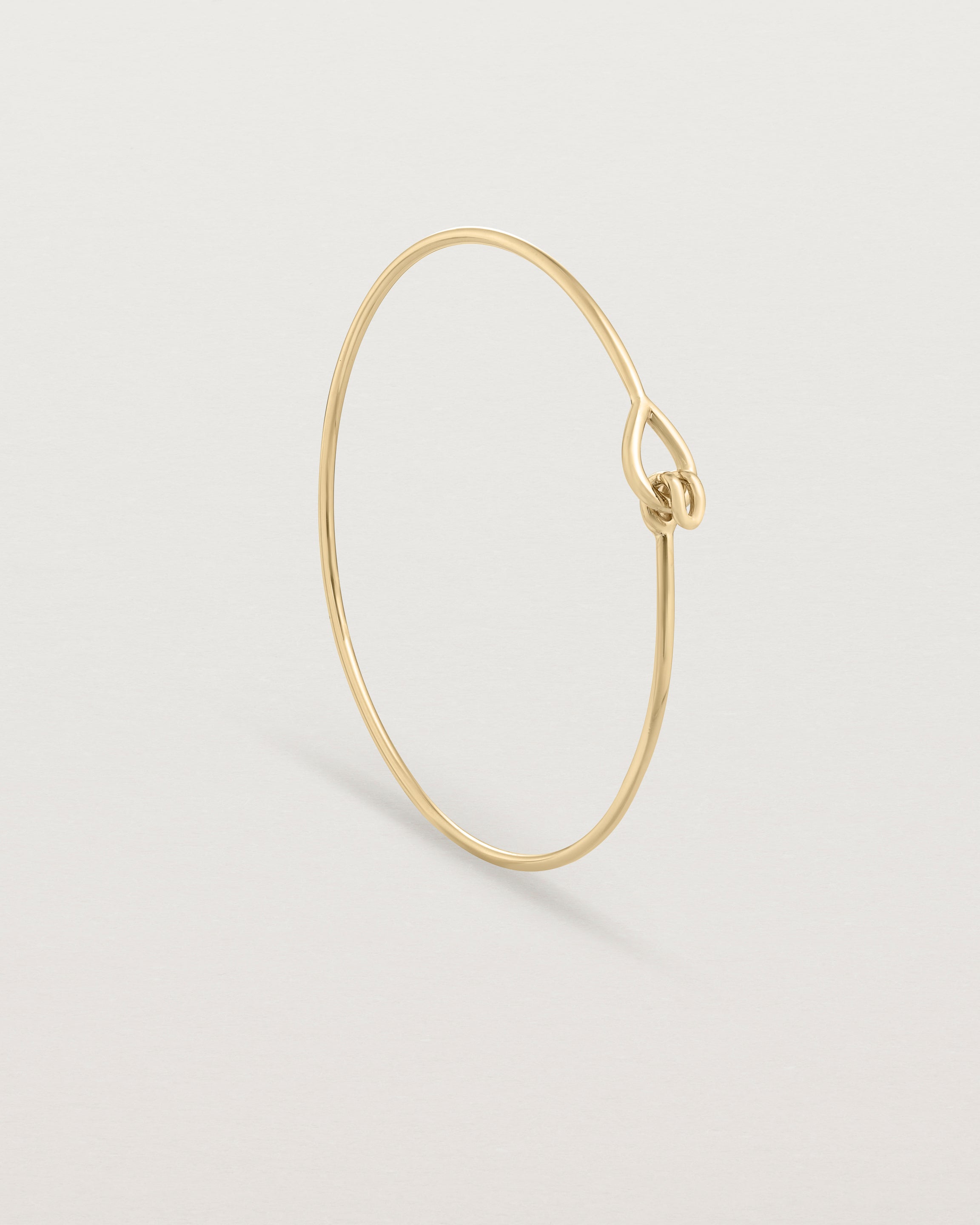 Standing view of the Oana Bangle in yellow gold.