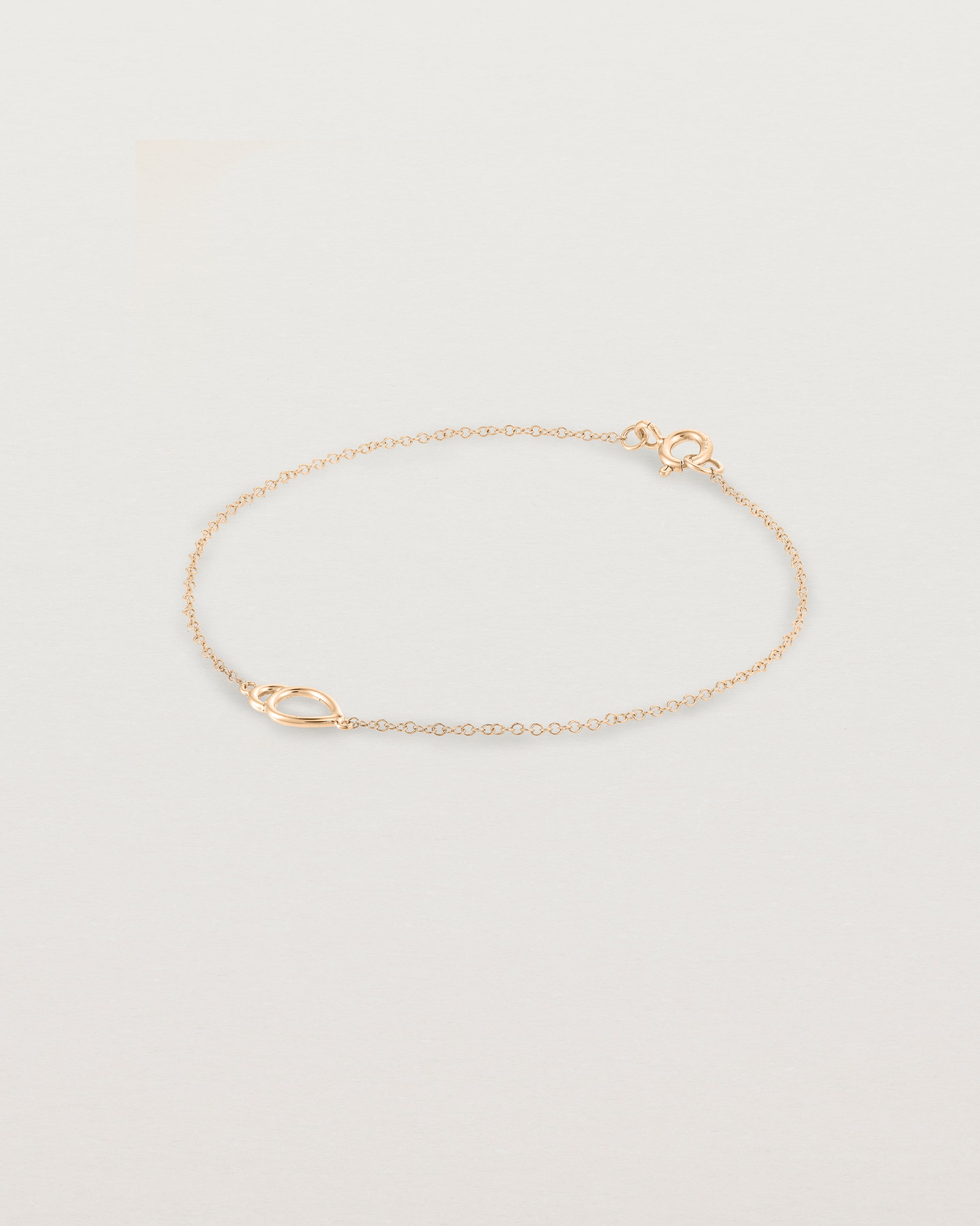 A rose gold chain with an oval pendant