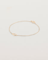 A rose gold chain with an oval pendant