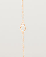 A rose gold chain with an oval pendant