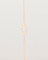 A rose gold chain with an oval pendant