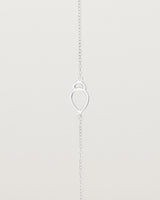 A sterling silver chain with an oval pendant