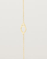 A yellow gold chain with an oval pendant