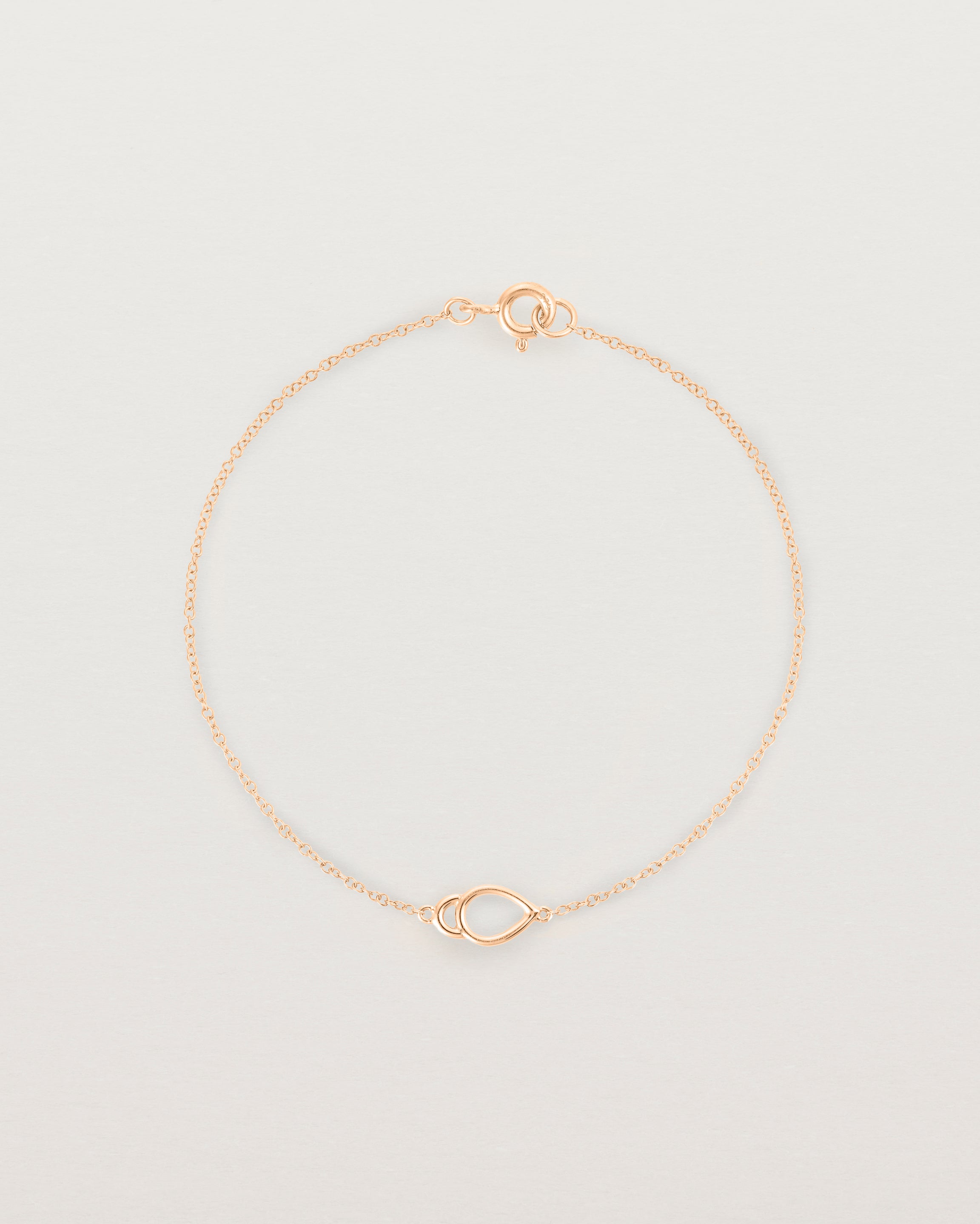 A rose gold chain with an oval pendant