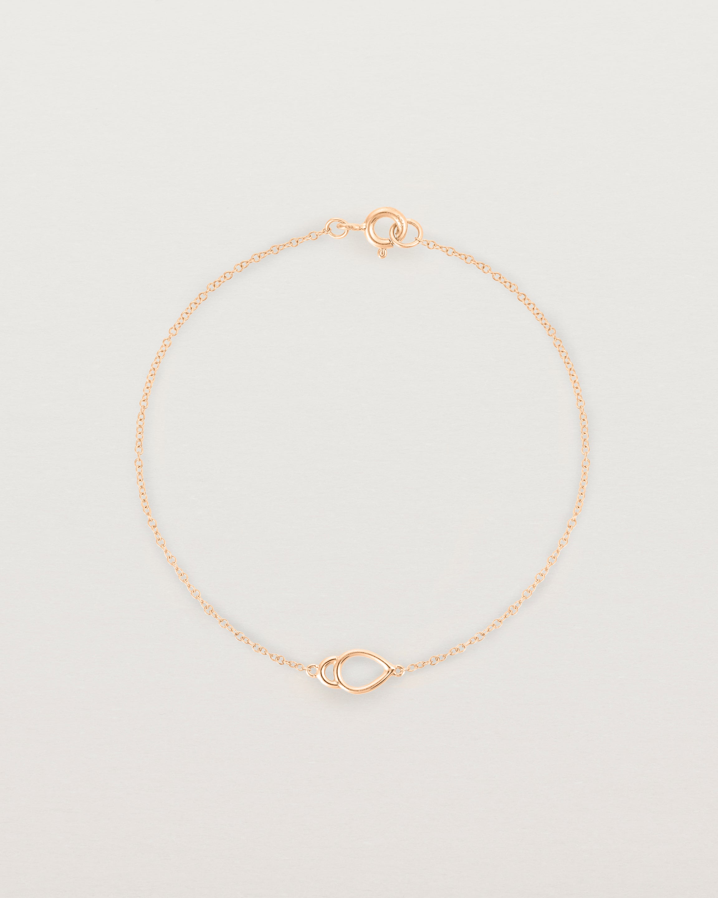 A rose gold chain with an oval pendant