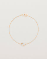 A rose gold chain with an oval pendant