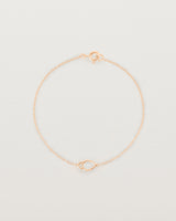 A rose gold chain with an oval pendant