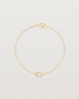 A yellow gold chain with an oval pendant