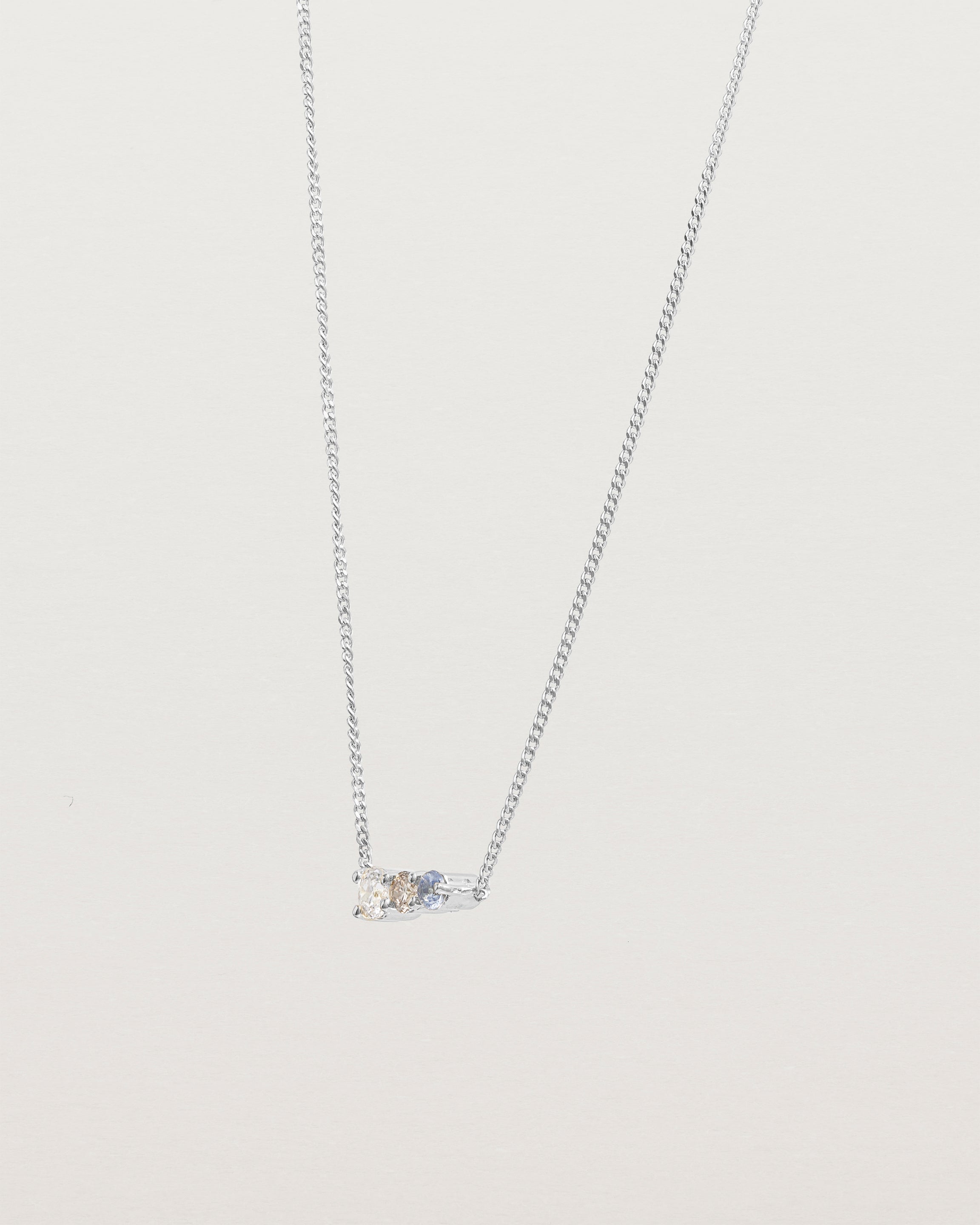 Angled view of the Ode Necklace | Diamond & Sapphire | White Gold